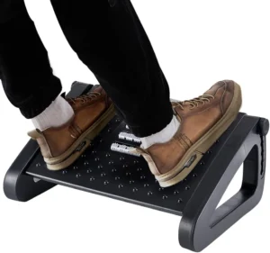 premium ergonomic home office setup with a wood rocking foot rest visible under the desk